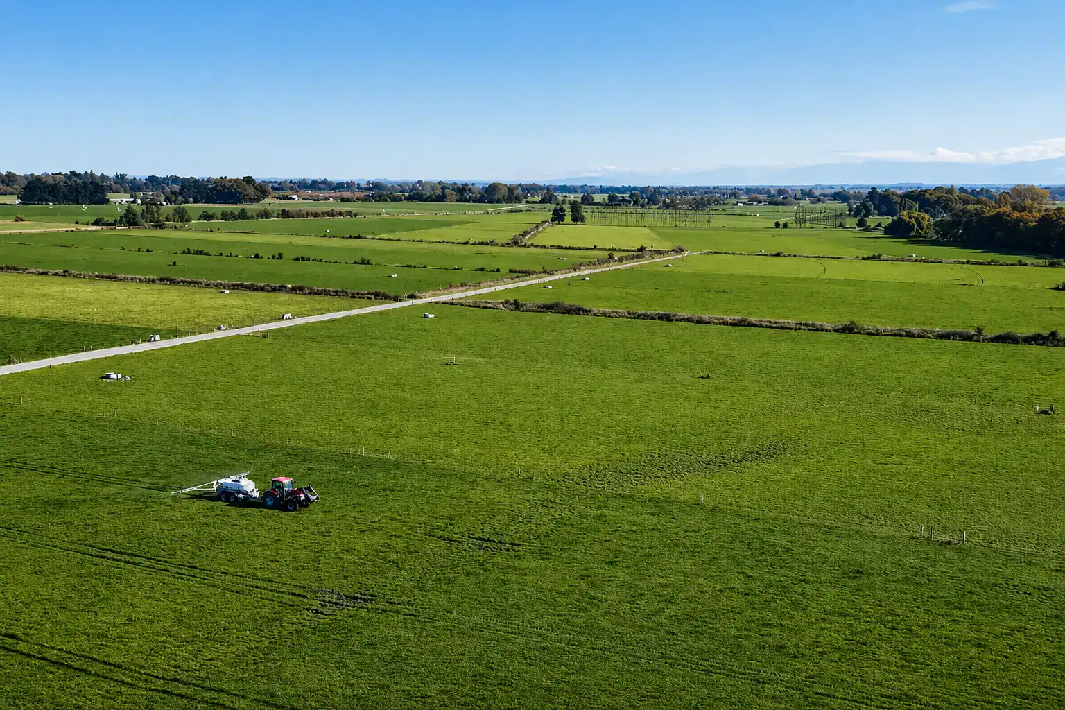 Aerial view of a tractor towing a Tow and Fert Multi 4000 across a paddock at Amy Stokes's farm near Christchurch