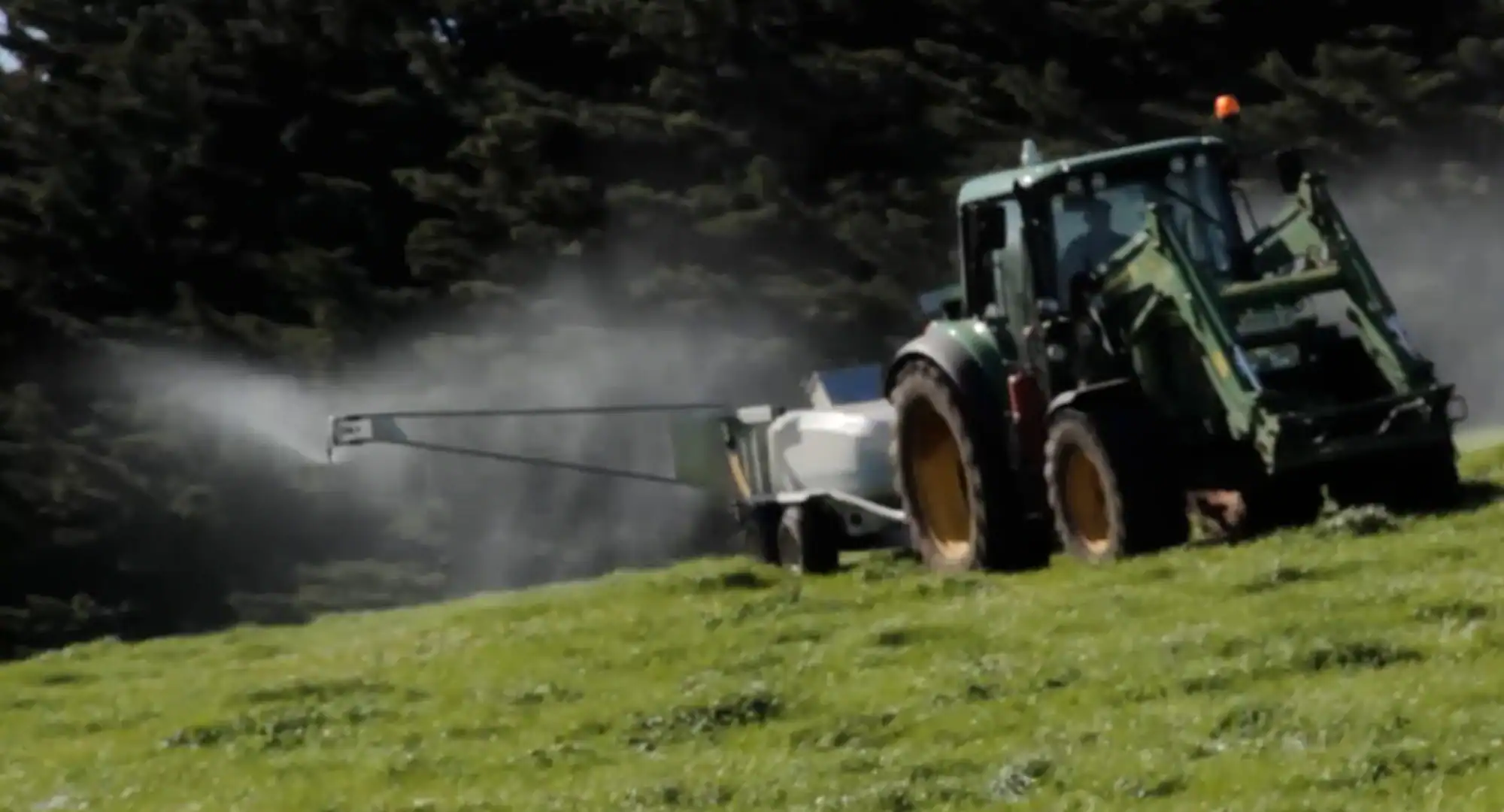 Tow and Fert being towed by tractor on a farm track, Mirboo North